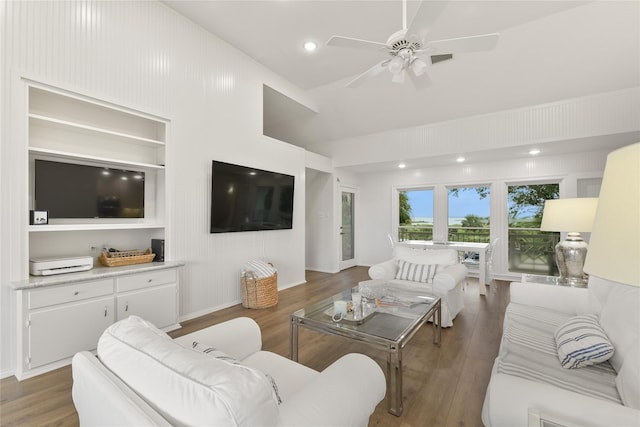 living room featuring built in shelves, recessed lighting, ceiling fan, and wood finished floors