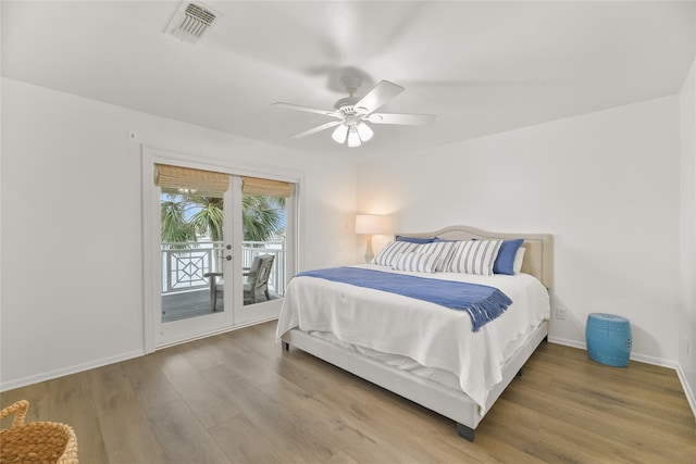 bedroom with access to exterior, french doors, visible vents, wood finished floors, and baseboards