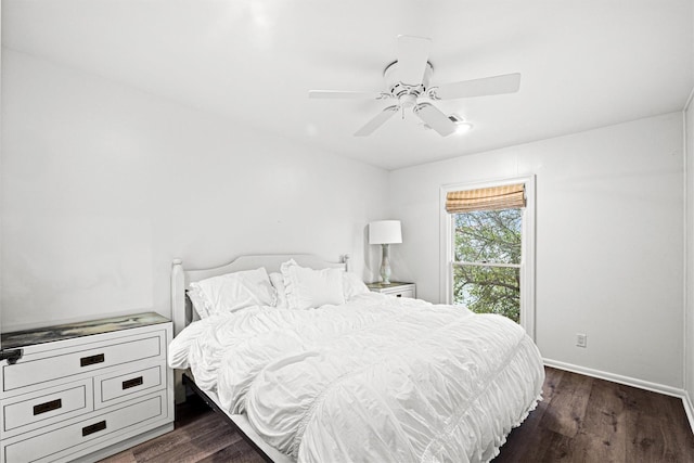 bedroom with a ceiling fan, baseboards, and wood finished floors