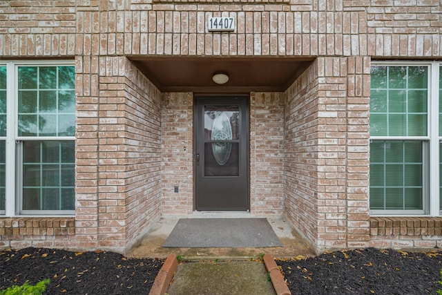 property entrance with brick siding