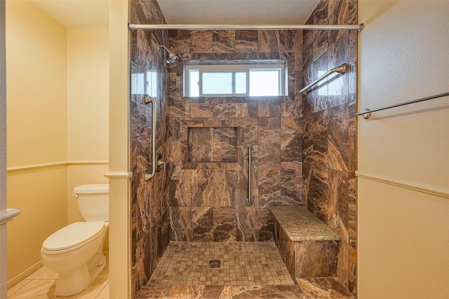 bathroom featuring a shower stall and toilet