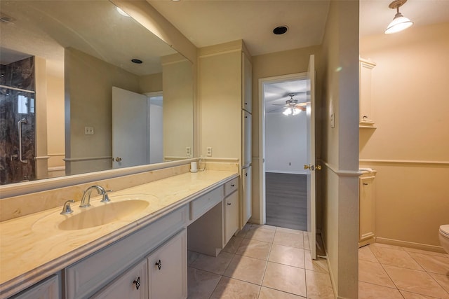 full bathroom featuring toilet, tile patterned flooring, vanity, and baseboards