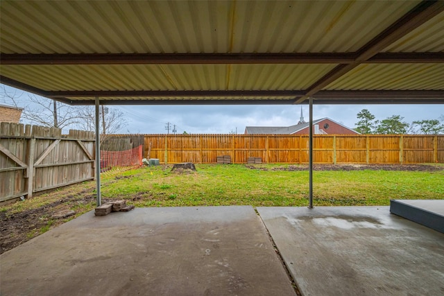 view of patio / terrace with a carport and a fenced backyard