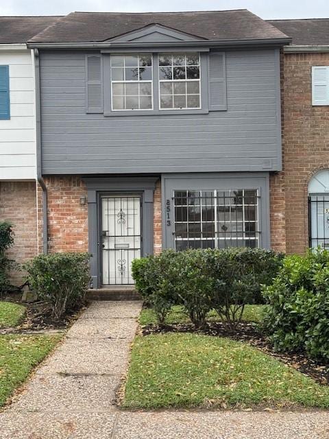 view of property featuring brick siding