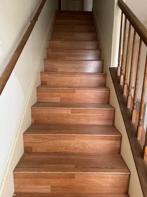 staircase with wood finished floors