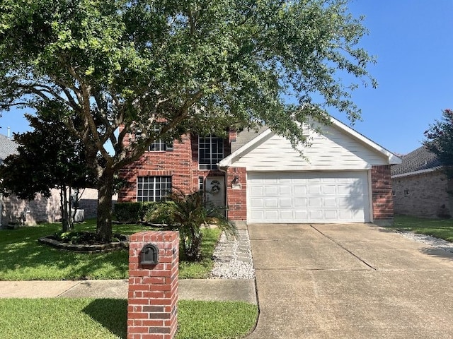 view of front of house featuring a garage, concrete driveway, and brick siding