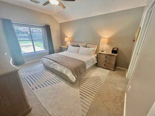 bedroom featuring light carpet, visible vents, baseboards, a ceiling fan, and lofted ceiling