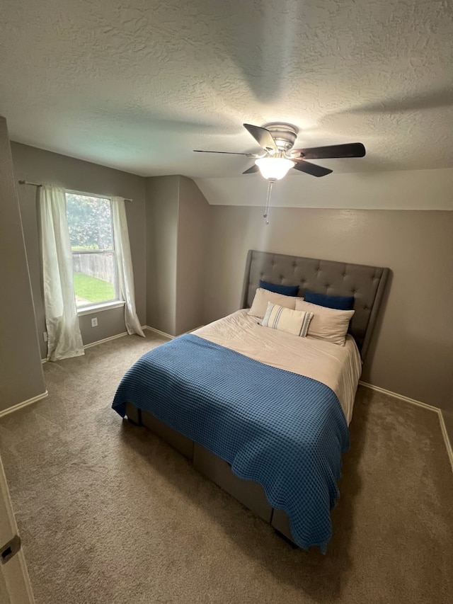 bedroom featuring carpet, ceiling fan, a textured ceiling, and baseboards