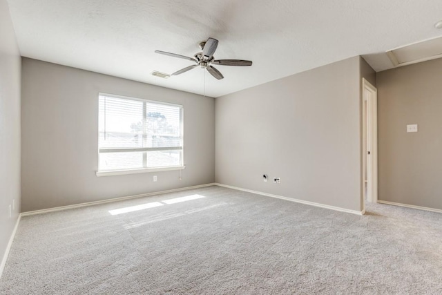 unfurnished room featuring baseboards, carpet floors, visible vents, and a ceiling fan