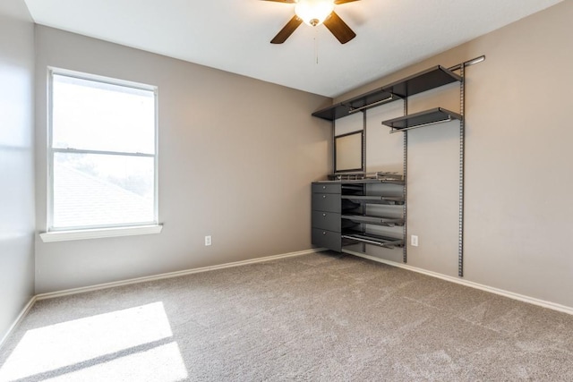 unfurnished bedroom featuring carpet, baseboards, and a ceiling fan