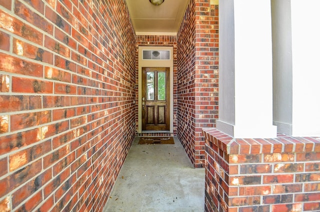 property entrance featuring brick siding