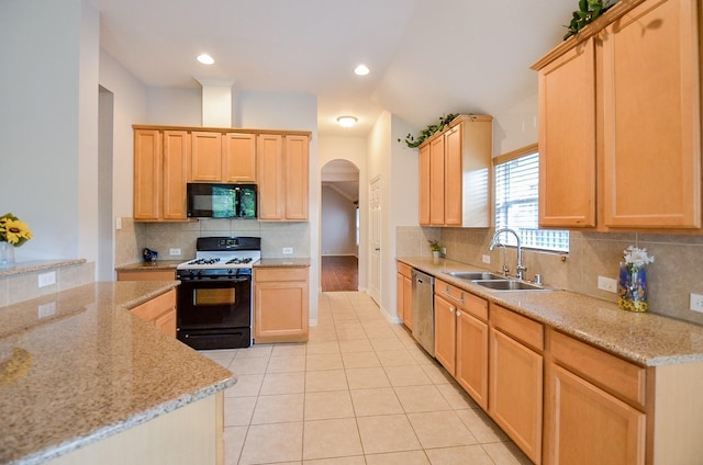 kitchen featuring black microwave, arched walkways, a sink, dishwasher, and gas stove