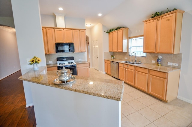 kitchen featuring black microwave, arched walkways, a sink, dishwasher, and gas range oven