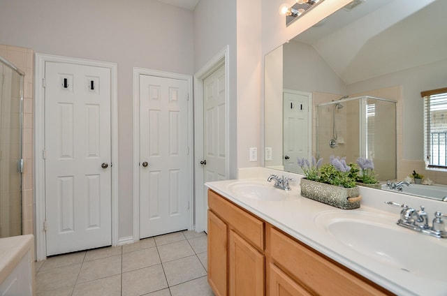 full bath featuring tile patterned flooring, a shower stall, and a sink