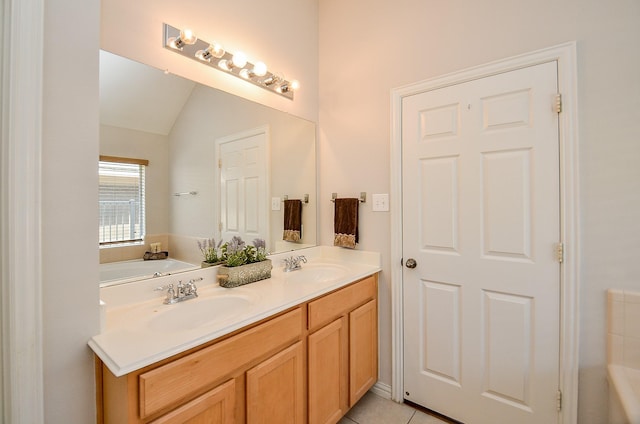 full bathroom with lofted ceiling, double vanity, tile patterned flooring, and a sink