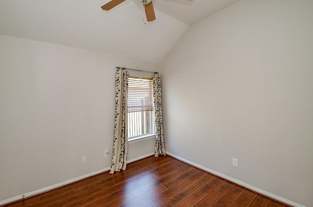 unfurnished room with a ceiling fan, vaulted ceiling, baseboards, and wood finished floors