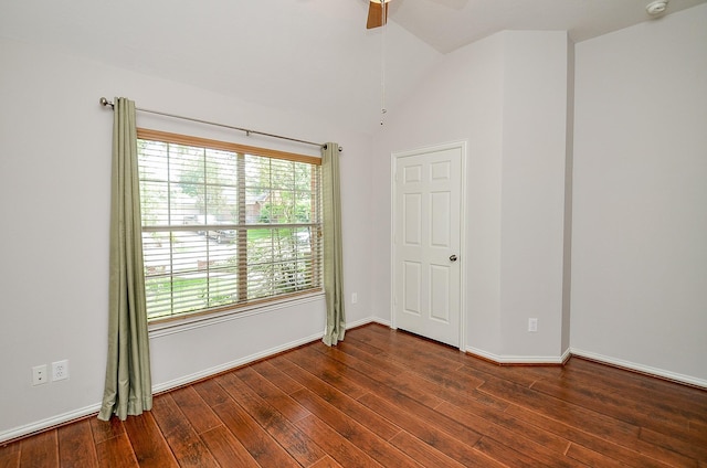 spare room featuring lofted ceiling, ceiling fan, baseboards, and dark wood finished floors