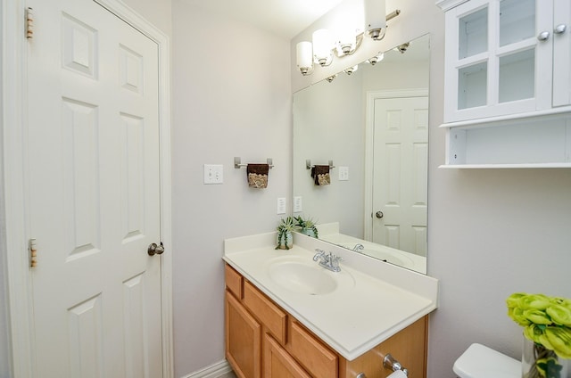 bathroom featuring toilet and vanity