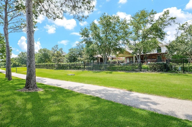 view of home's community featuring a yard and fence