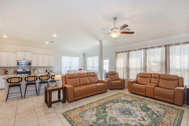 living area featuring ceiling fan, recessed lighting, crown molding, and light tile patterned floors