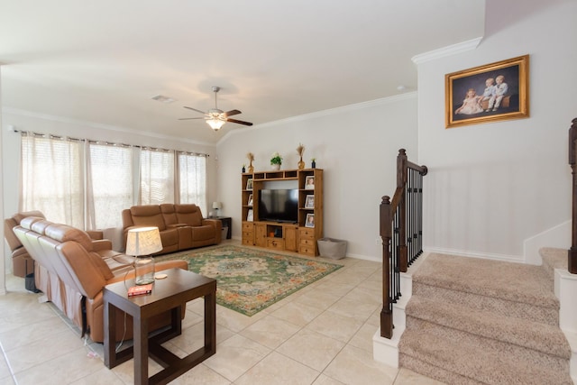 living area with light tile patterned floors, visible vents, ceiling fan, ornamental molding, and stairs