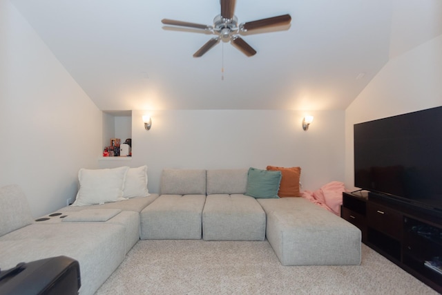 living area with vaulted ceiling, carpet, and a ceiling fan