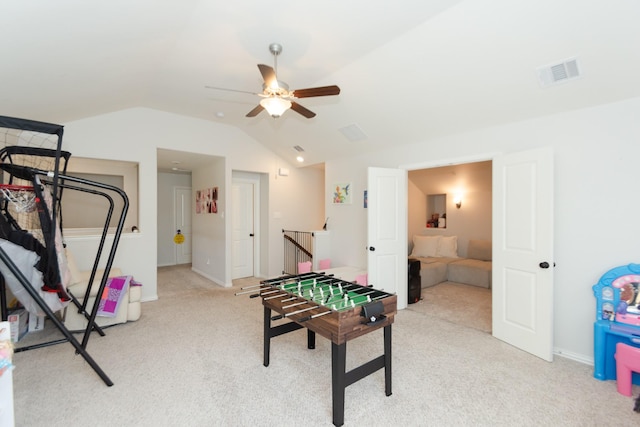 recreation room with carpet, visible vents, a ceiling fan, vaulted ceiling, and baseboards