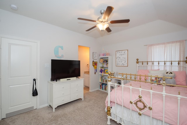 carpeted bedroom with a ceiling fan, lofted ceiling, baseboards, and ensuite bathroom