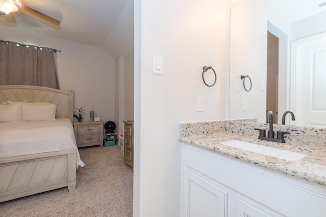 interior space with lofted ceiling, visible vents, a ceiling fan, and vanity