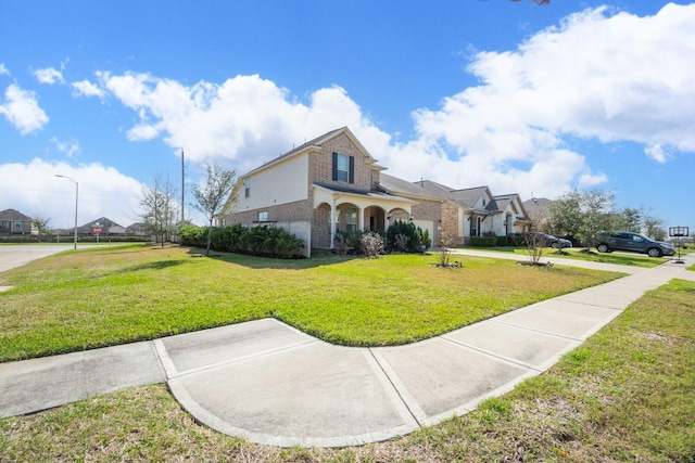 traditional-style house with brick siding, concrete driveway, and a front yard