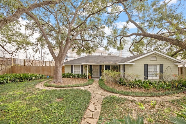 ranch-style house with fence and brick siding