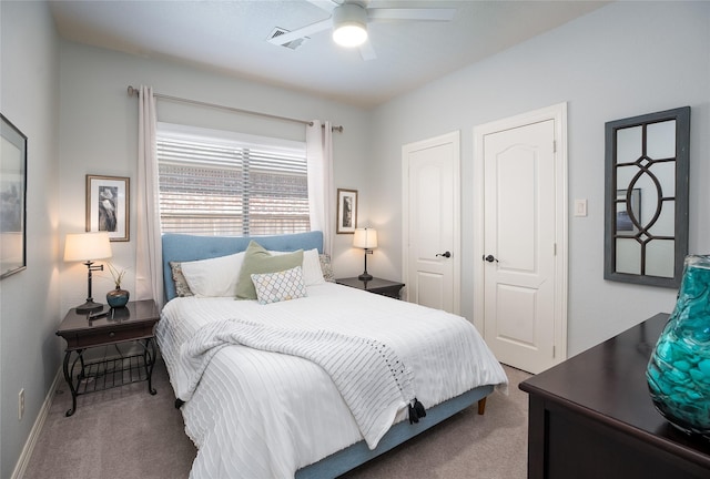 carpeted bedroom with ceiling fan, visible vents, and baseboards