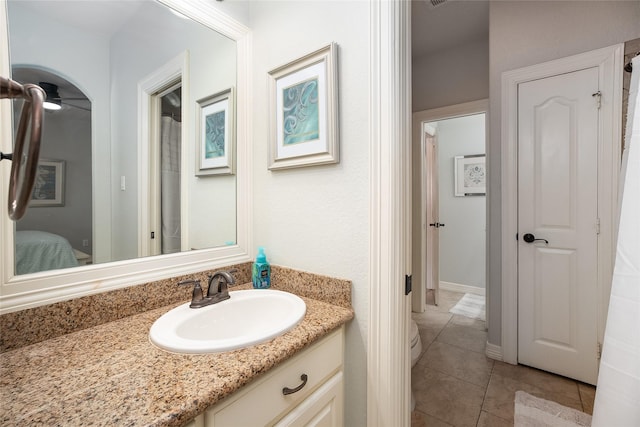 bathroom featuring tile patterned floors, connected bathroom, and vanity