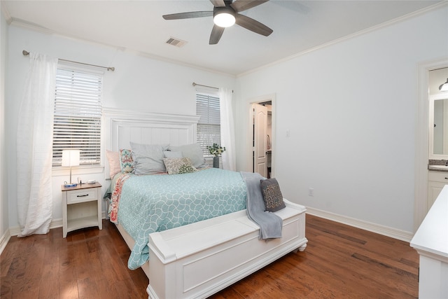 bedroom featuring ornamental molding, wood finished floors, visible vents, and baseboards