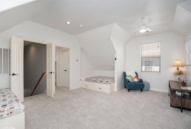 bedroom with light carpet, vaulted ceiling, baseboards, and ceiling fan