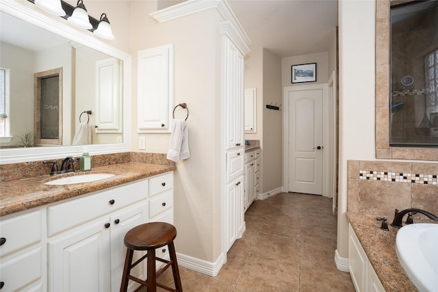 full bath featuring tile patterned flooring, a garden tub, vanity, and baseboards