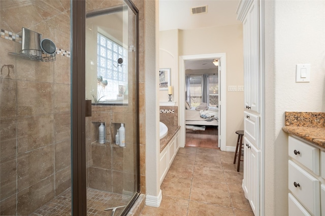 ensuite bathroom with visible vents, ensuite bathroom, a shower stall, vanity, and tile patterned flooring