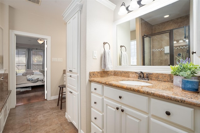 ensuite bathroom with a stall shower, ensuite bath, vanity, and a healthy amount of sunlight