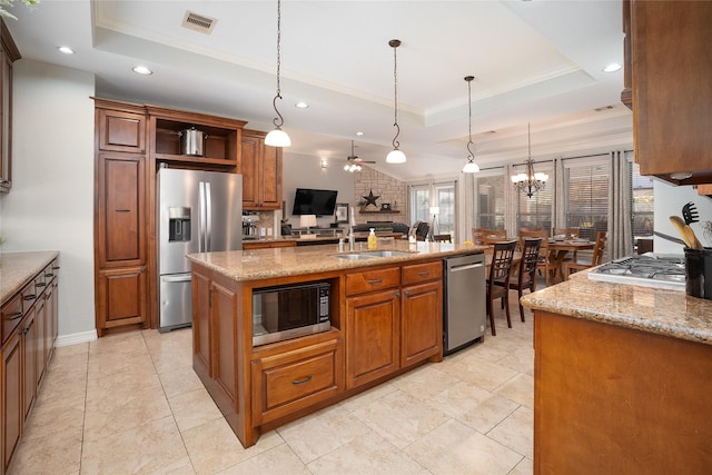 kitchen featuring stainless steel appliances, a raised ceiling, visible vents, and pendant lighting