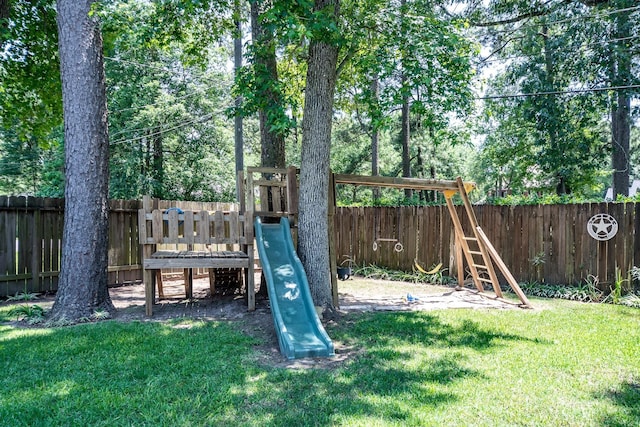 view of jungle gym with a lawn and a fenced backyard