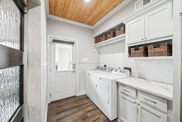 laundry area featuring cabinet space, wooden ceiling, ornamental molding, dark wood-style flooring, and washing machine and dryer