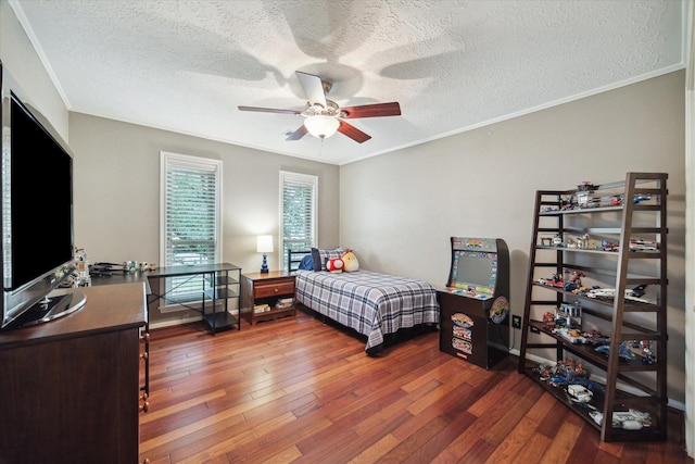 bedroom featuring wood-type flooring, ornamental molding, and a textured ceiling