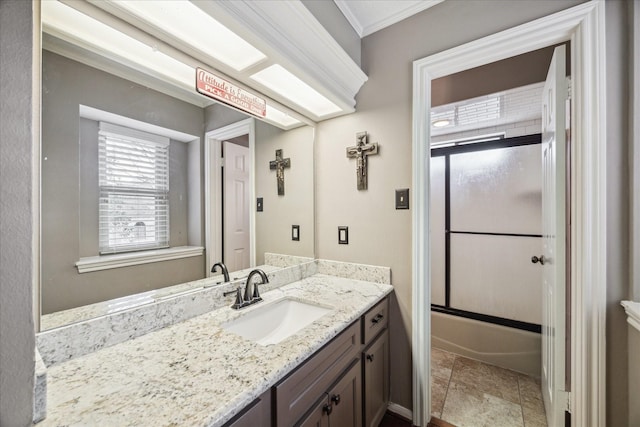 bathroom with crown molding, shower / bath combination with glass door, and vanity