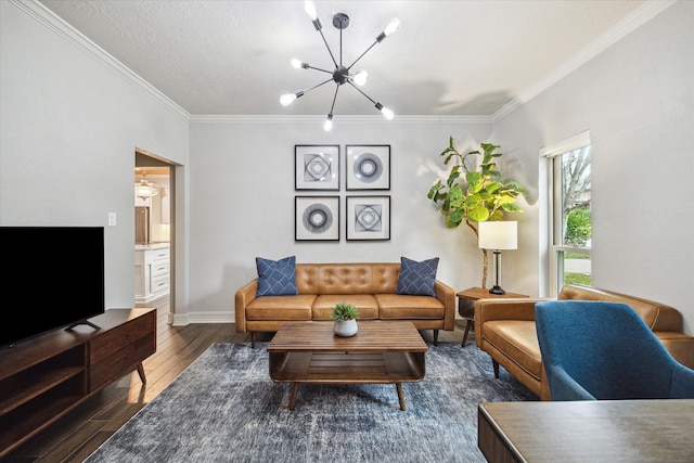 living area with baseboards, ornamental molding, wood finished floors, a textured ceiling, and a chandelier