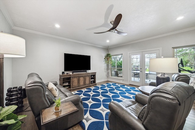 living room featuring a ceiling fan, french doors, ornamental molding, and wood finished floors