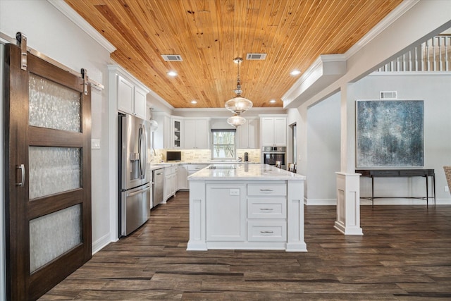 kitchen with visible vents, white cabinets, appliances with stainless steel finishes, ornamental molding, and light countertops