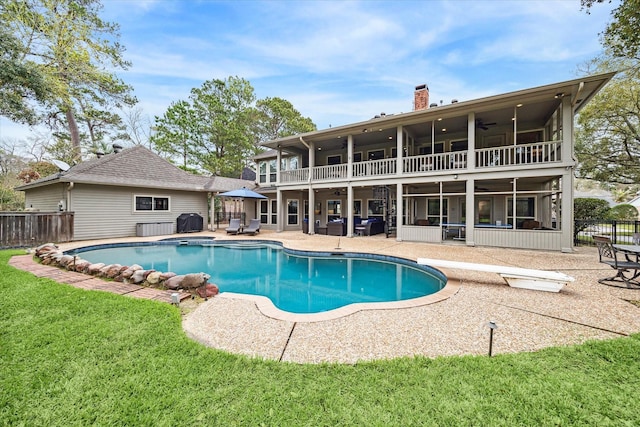 view of swimming pool with a fenced in pool, a ceiling fan, a sunroom, a patio area, and fence