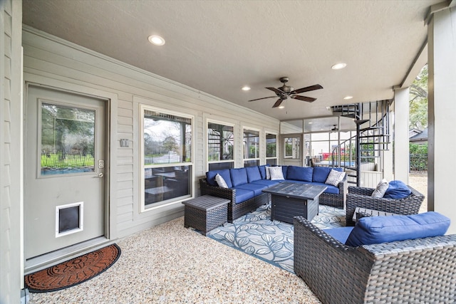 sunroom featuring a ceiling fan