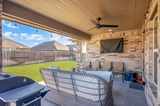 view of patio / terrace with a ceiling fan, area for grilling, and a fenced backyard