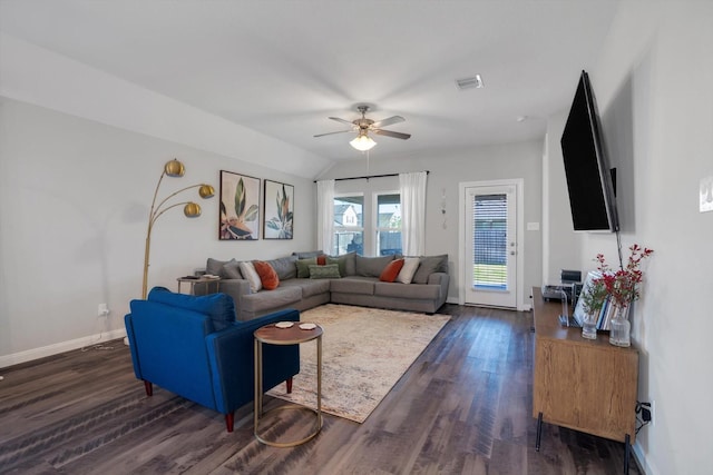 living area with visible vents, baseboards, dark wood-style flooring, ceiling fan, and vaulted ceiling